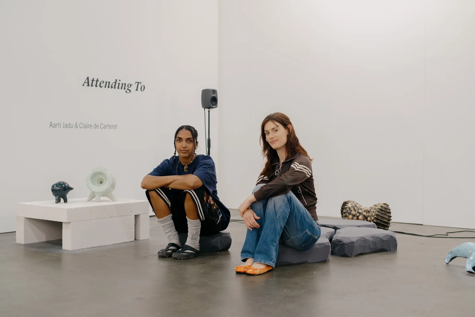 Aarti Jadu and Claire de Carteret sitting on their sound and installation work