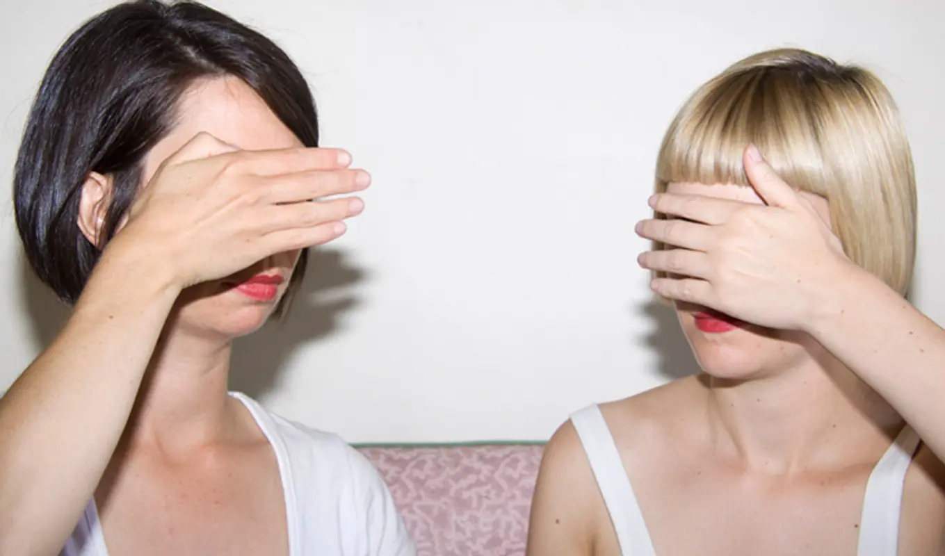 Two people with bobs with their hands covering their eyes.