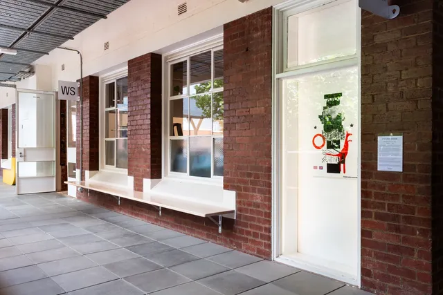 A print is exhibited outside the gallery.