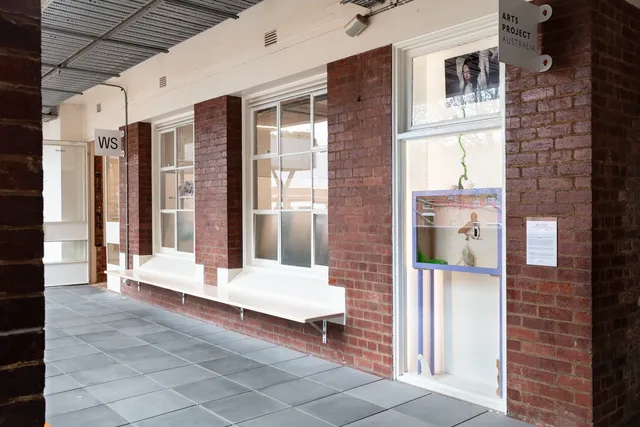 Exterior view of West Space with Yanti Pengs 'Self-made: Invisible Architectures' showing in the window.
