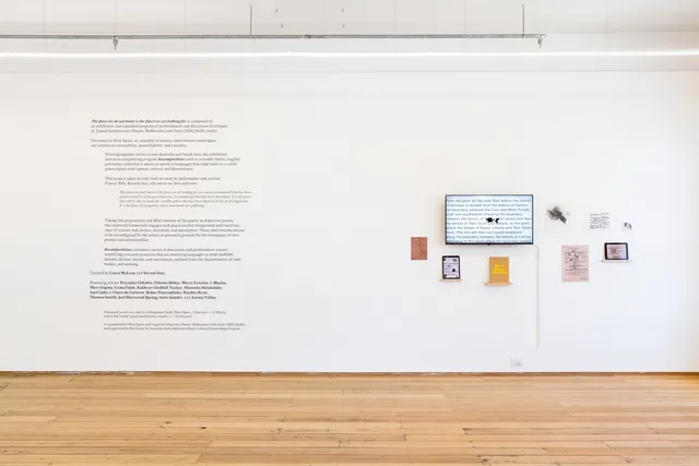 Exhibition text at the left, an installation at the right.