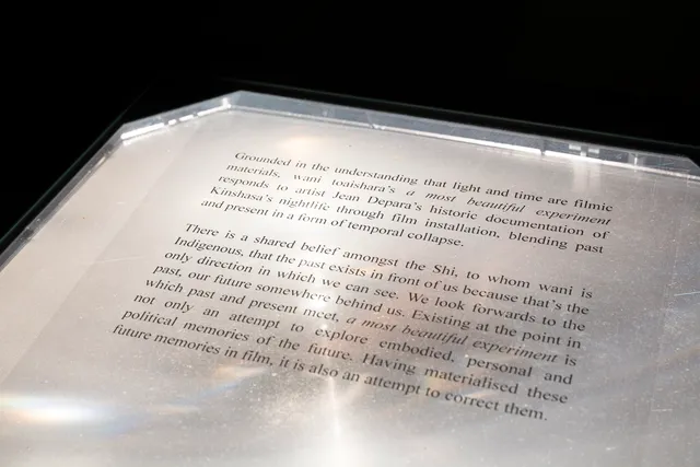 Some text on a transparent sheet sits lightly on an old projector surface.