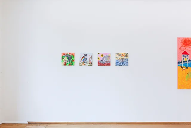 Installation view of Peter Waples-Crowe's untitled series of four small square paintings are hung in a horizontal line on a white wall. The image on the far left is of two anthropomorphic dingos, one of which is holding a baby dingo inside a blanket. The image perspective is from above and distorts into the background, which is a rusty red tone along the top. The bottom two thirds is a vibrant green with yellow spots, interrupted by a segment of greyscale paper collage. The next painting again includes the humanised dingo, which is standing in a black hole, waving its arms. There is a blue sky with a rainbow, a section of greyscale paper collage, and balls of fire flying across the sky. In the foreground, there are large rocks scattered across the dirt and a small but bright fire. The third painting has a blotchy pink background covering the top two thirds, with silouhettes of dingo heads in yellow circles, and dark red teardrop shapes covering the bottom third. The greyscale paper collage form, with a pale pink crucifix in the centre, shelters three dingos, two of which are cradelling the third, which appears to be dead. The final painting depicts a grey collage boat floating in a blue sea made up of dingo faces. The top half of the painting is a yellow sky with grey clouds, stars, and a rainbow. There are two dingos in the boat, one standing up with arms raised and one lying down.