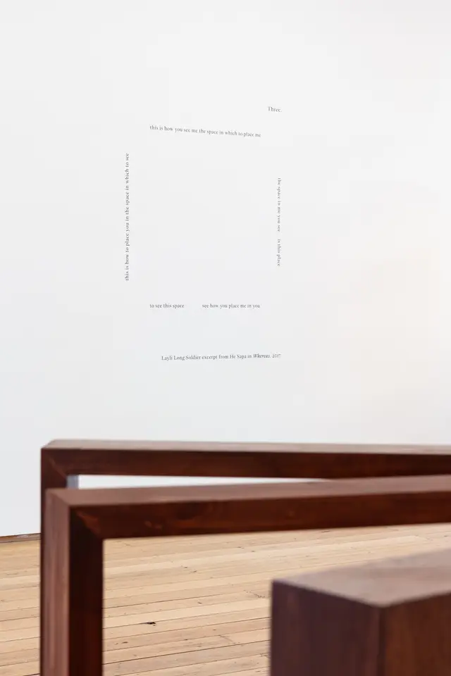 View of installation text on the gallery wall, set out in a square.