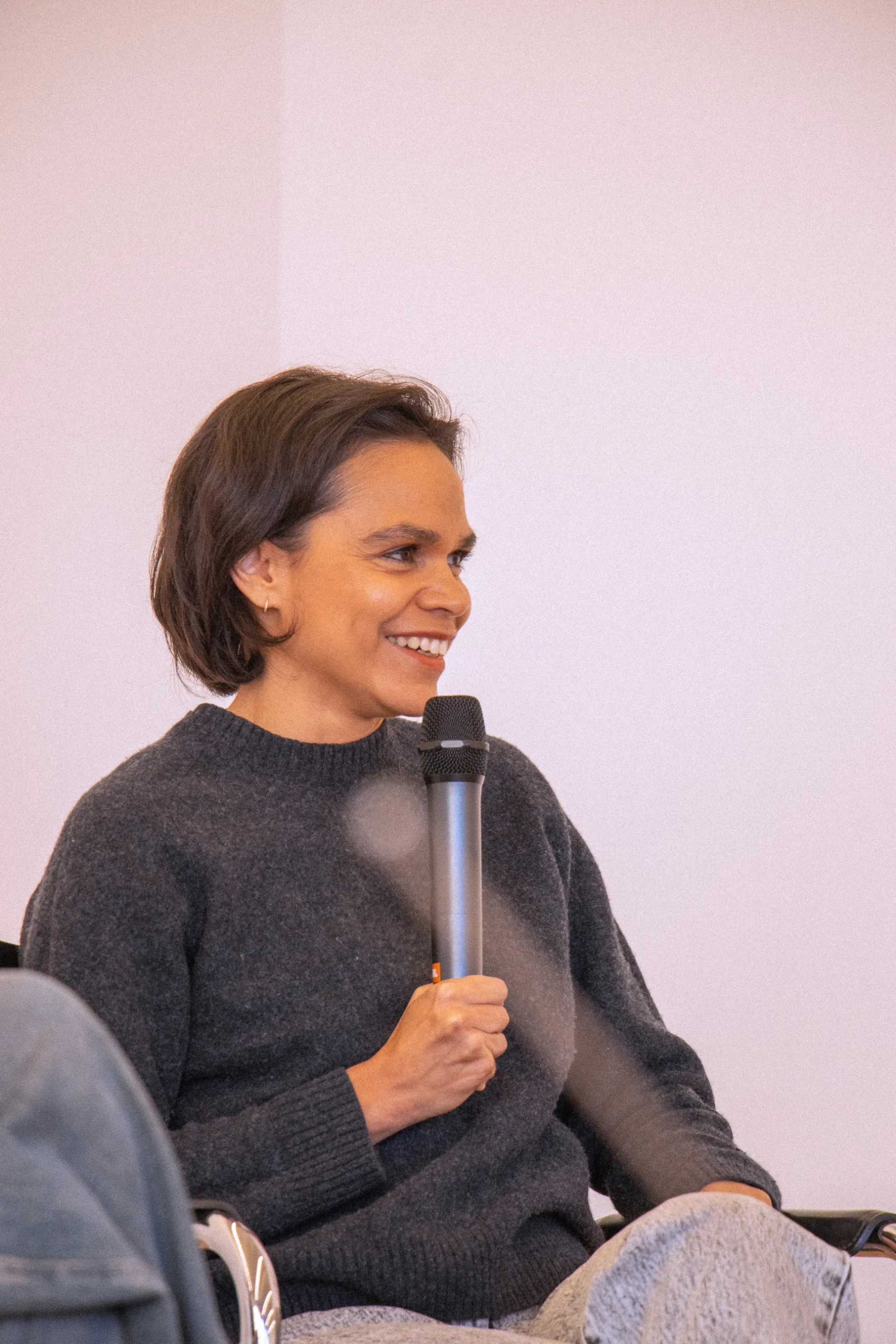 Katie smiling while holding the microphone.