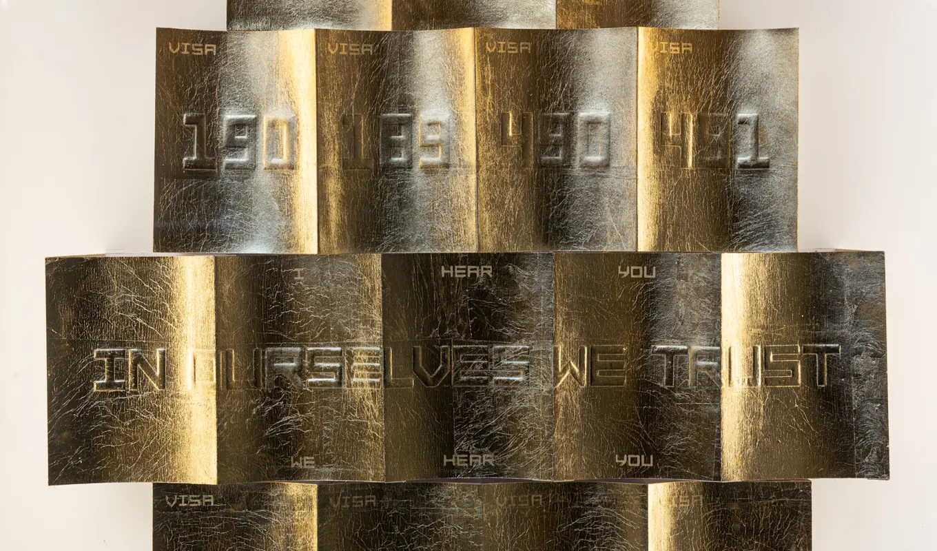 A close up detail on Thang Do's artwork of gold embossed visa codes. Visible text within the artwork reads "I hear you. We hear you" and "In ourselves we trust"