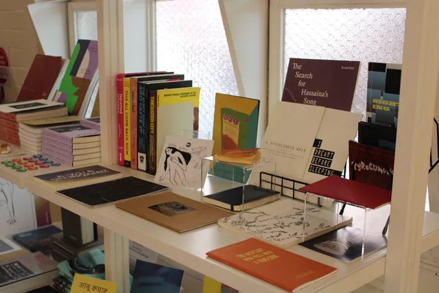 A shot of the book shelves or library at West Space Gallery, from a side angle. Various artist books and publication types are on display neatly for presentation and sale.