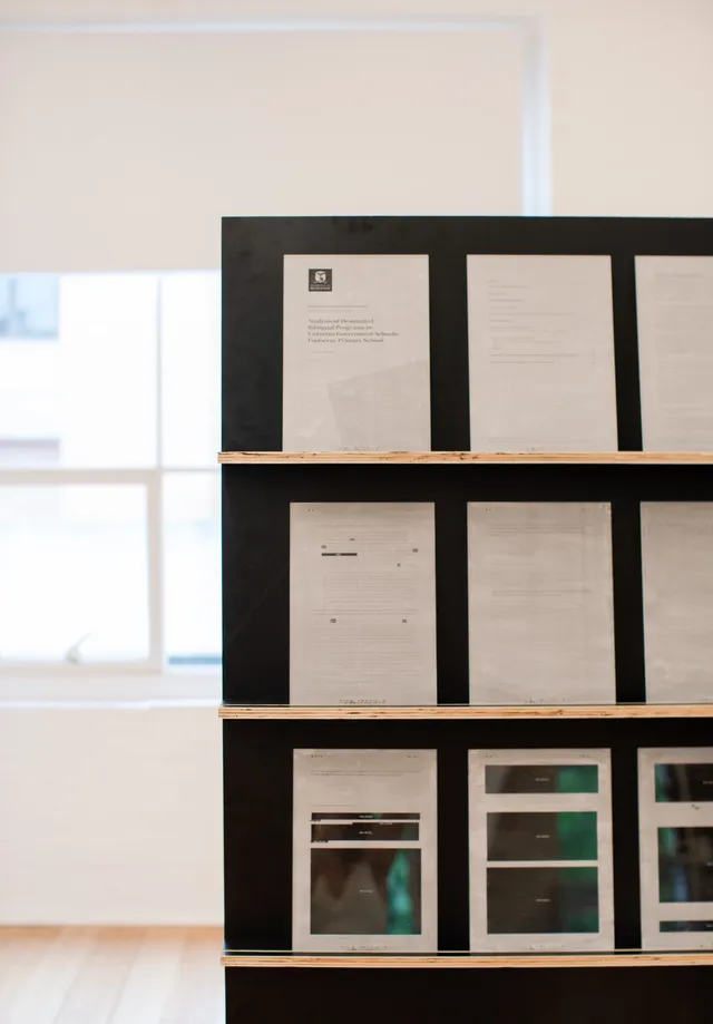 The corner of a large book platform, acting as a front-facing shelf in black.