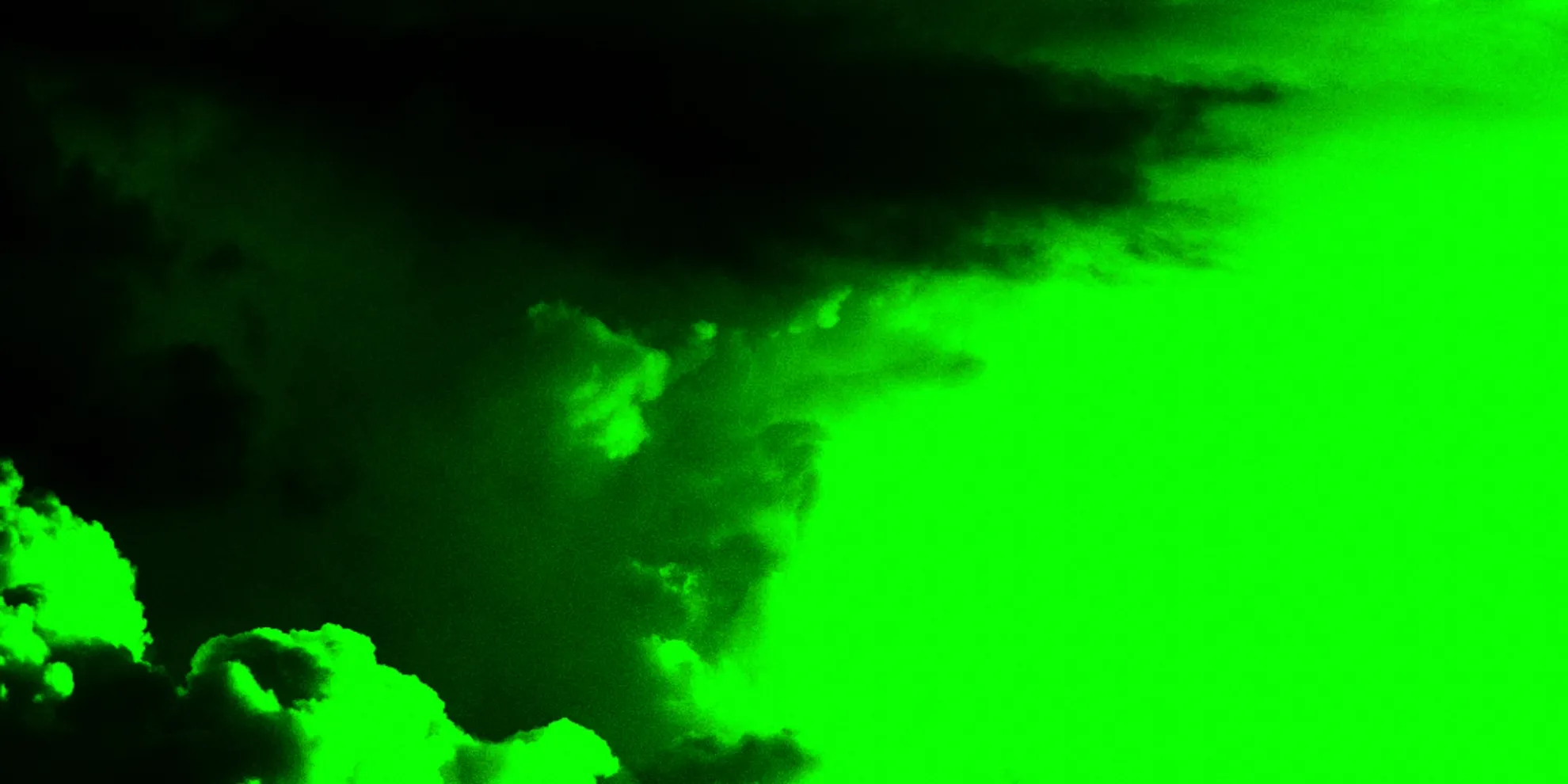 A dark, cloud-like shape appears against a bright green background, creating a stark contrast.