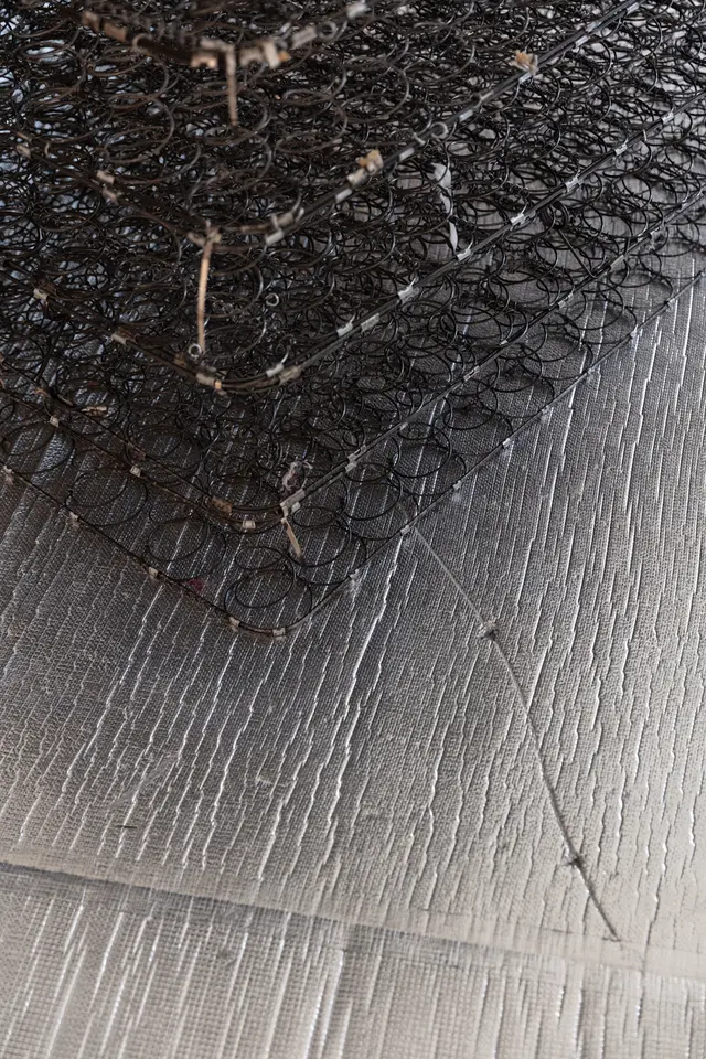 Layers of metal springs of mattresses placed on a foil mat.