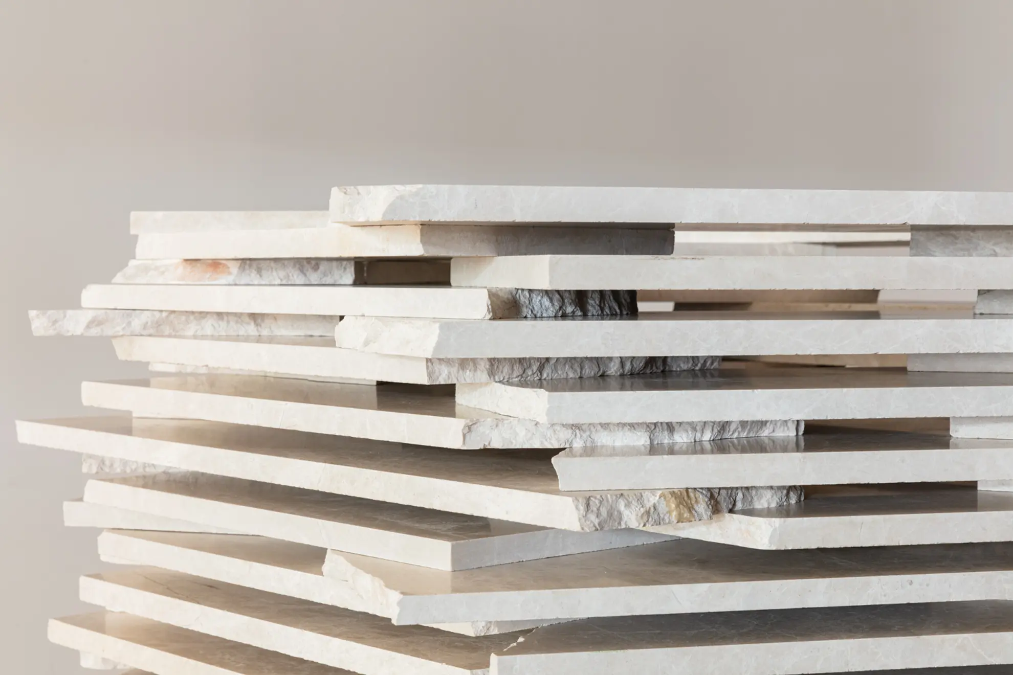 A close up detail of a stacked marble artwork showing larger stacked sheets of white marble with gaps between the layers.
