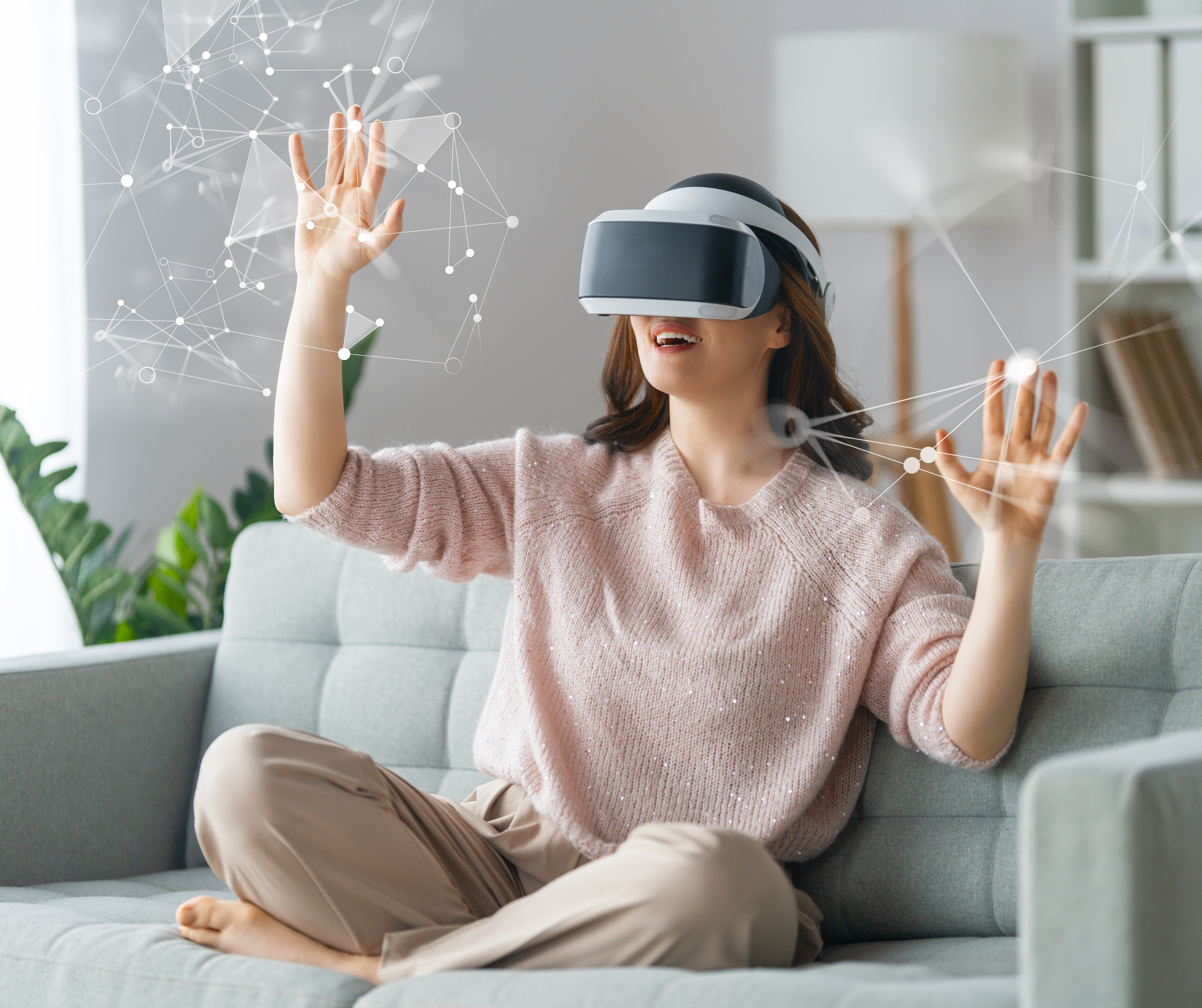 A woman enjoying a virtual reality shopping experience at home, using a VR headset and interacting with digital elements.