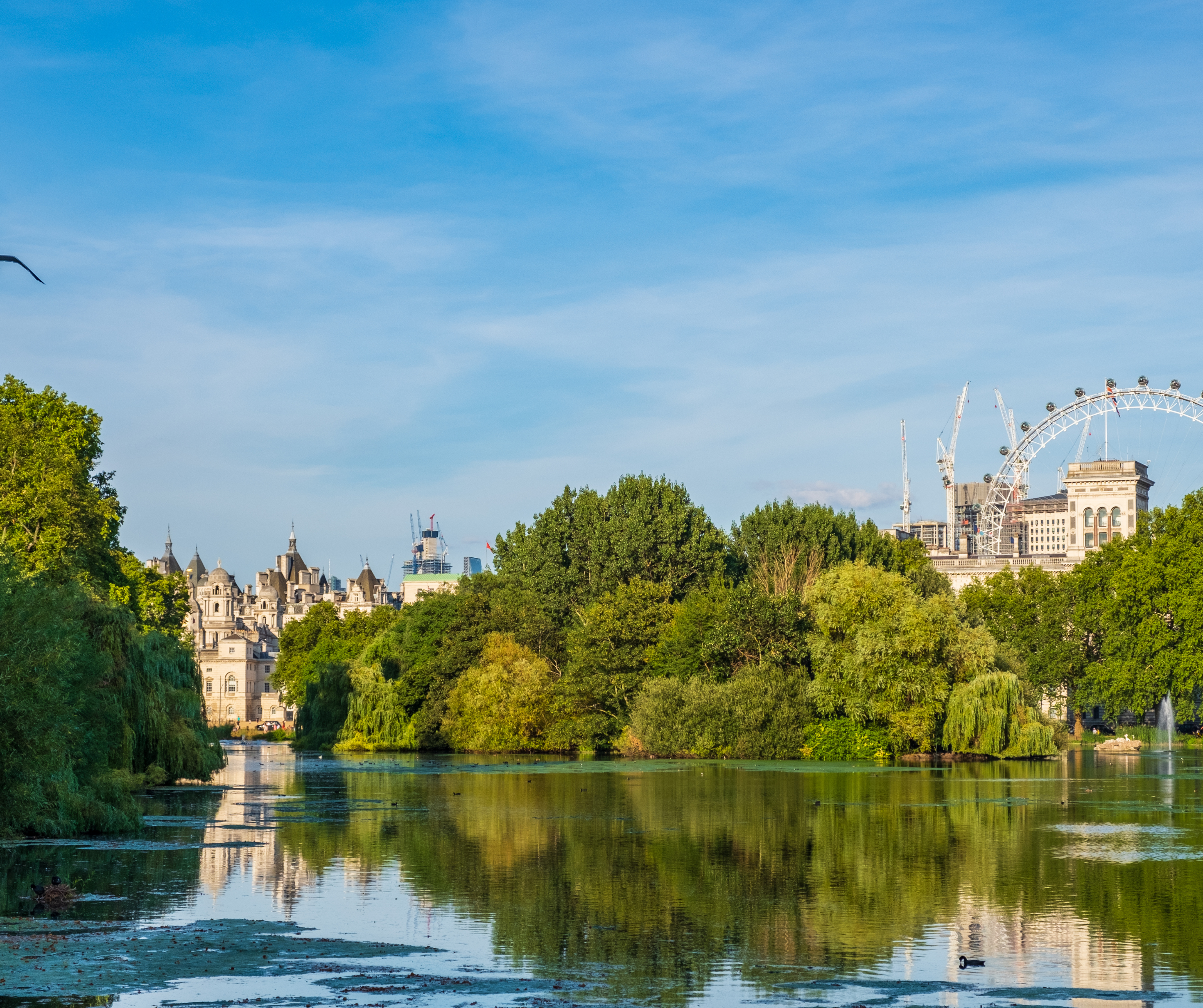 Daytime view of London's skyline with the Shard and River Thames prominent in the foreground.