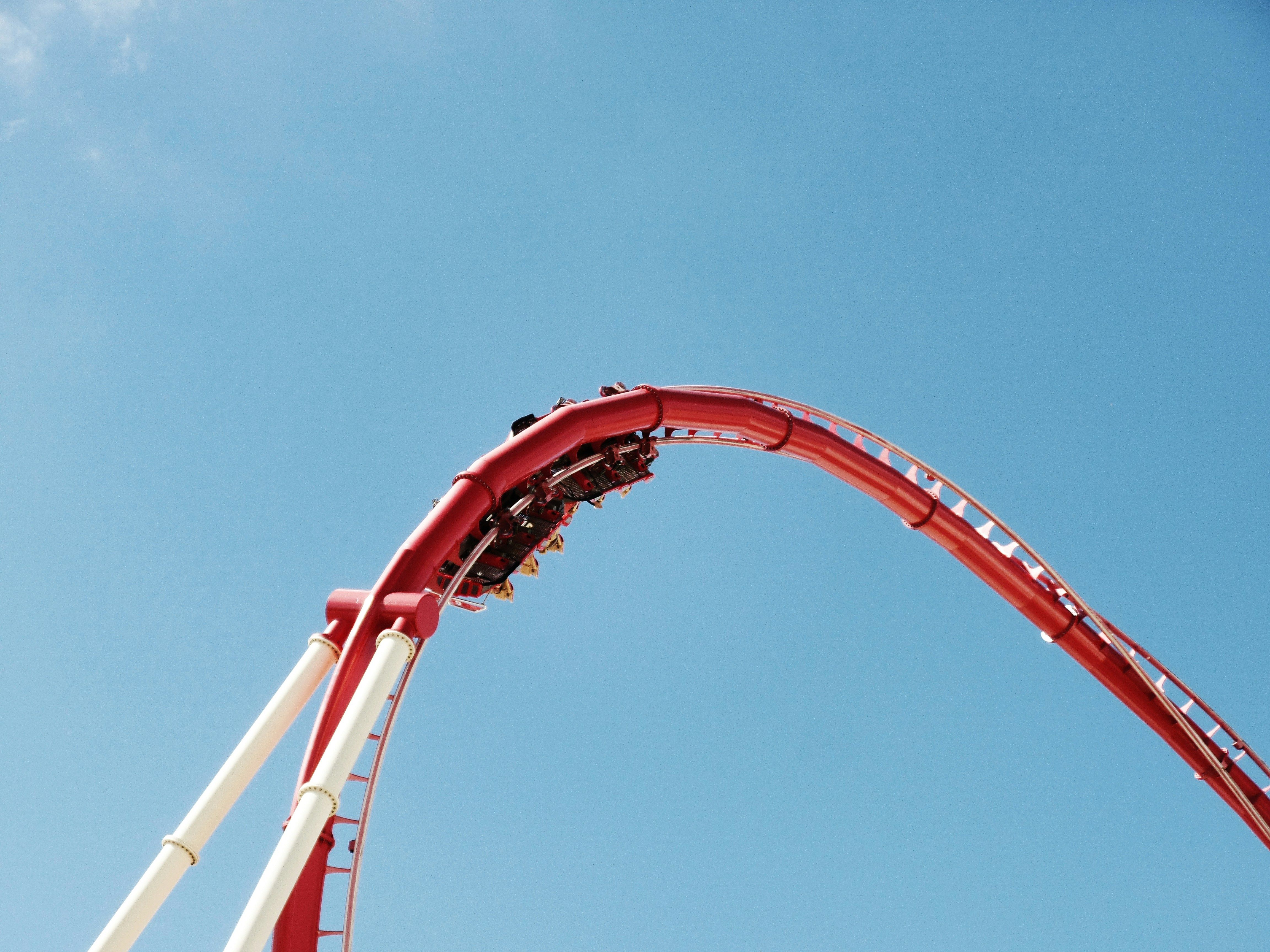 An amusement park train ride with excited passengers enjoying the ride.