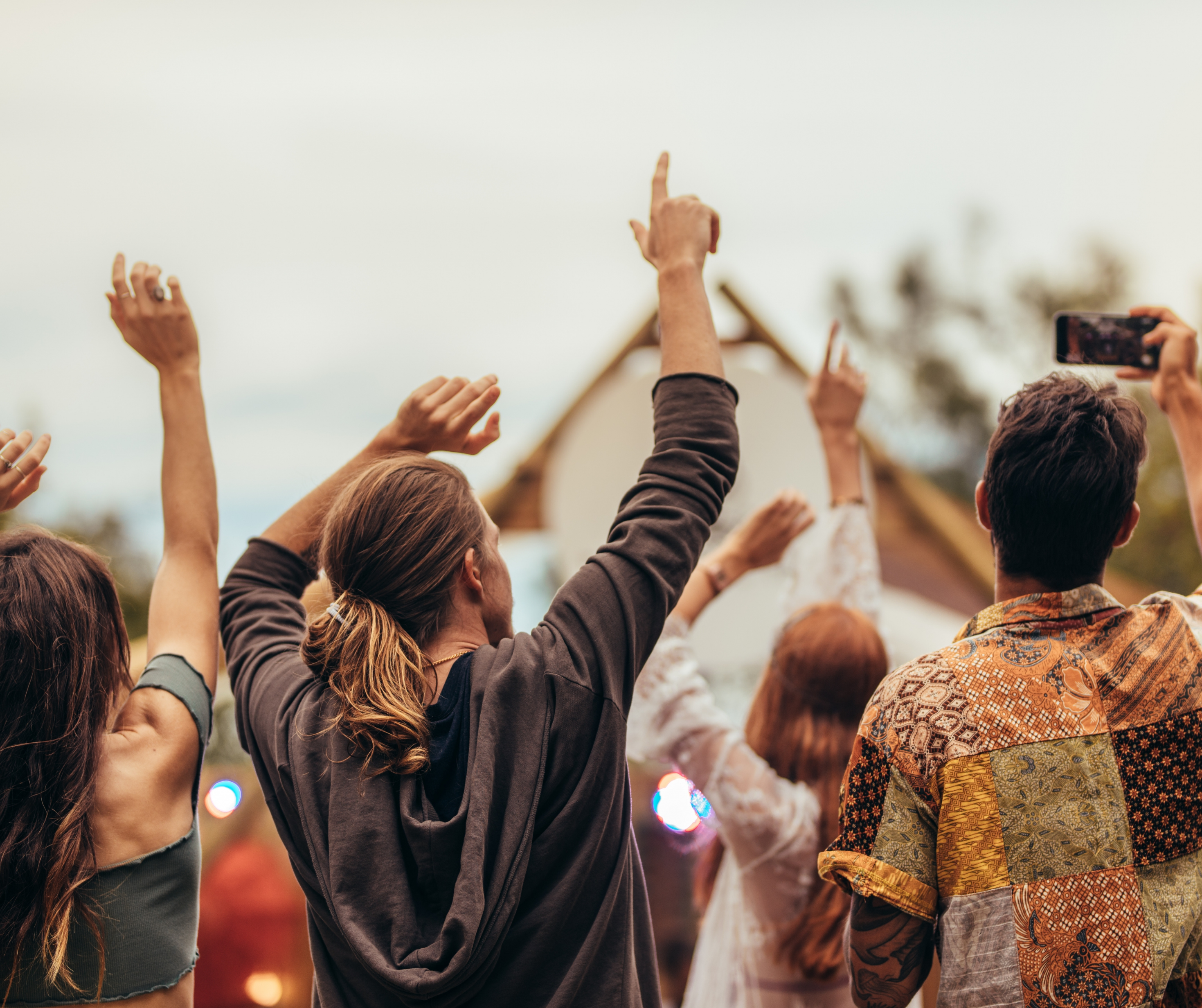 A lively festival featuring live music and crowds dancing joyfully.