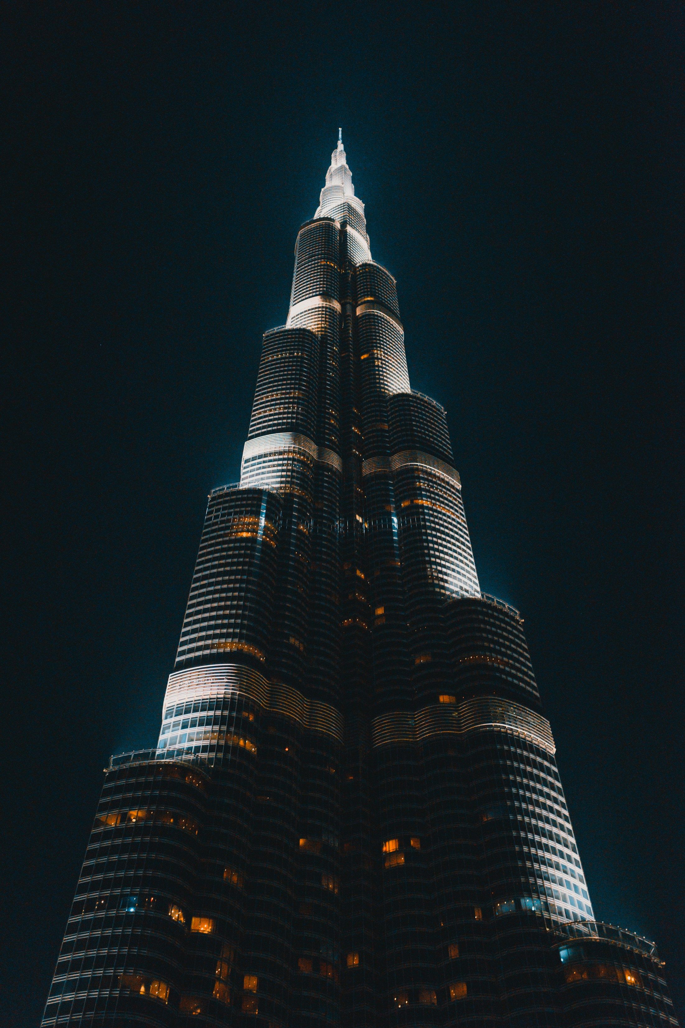 Close-up night view of the illuminated Burj Khalifa skyscraper against a dark sky