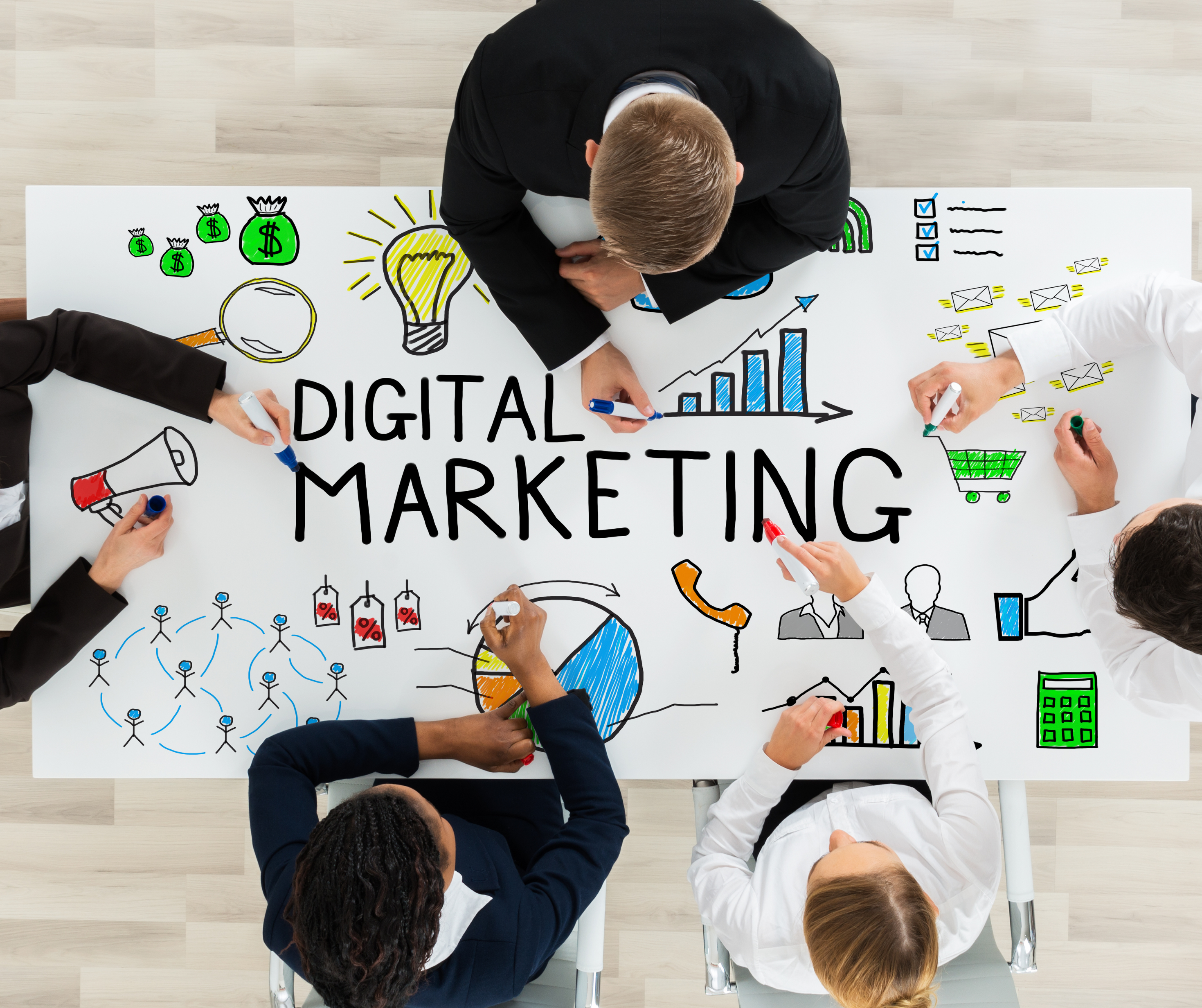 A team of professionals working on a digital marketing strategy, with various icons and charts on the table.