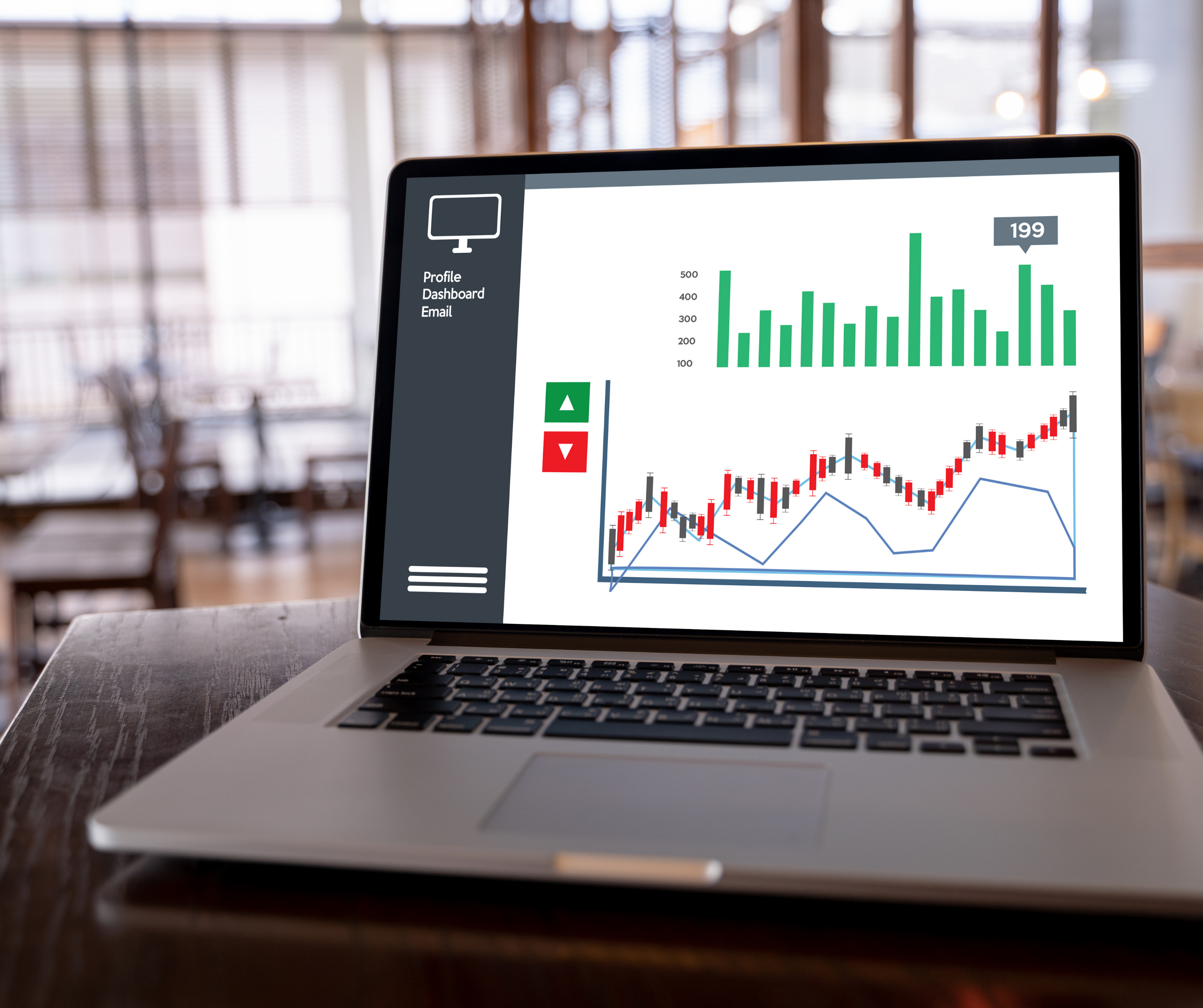 Laptop displaying market trends and data analysis with bar charts and line graphs