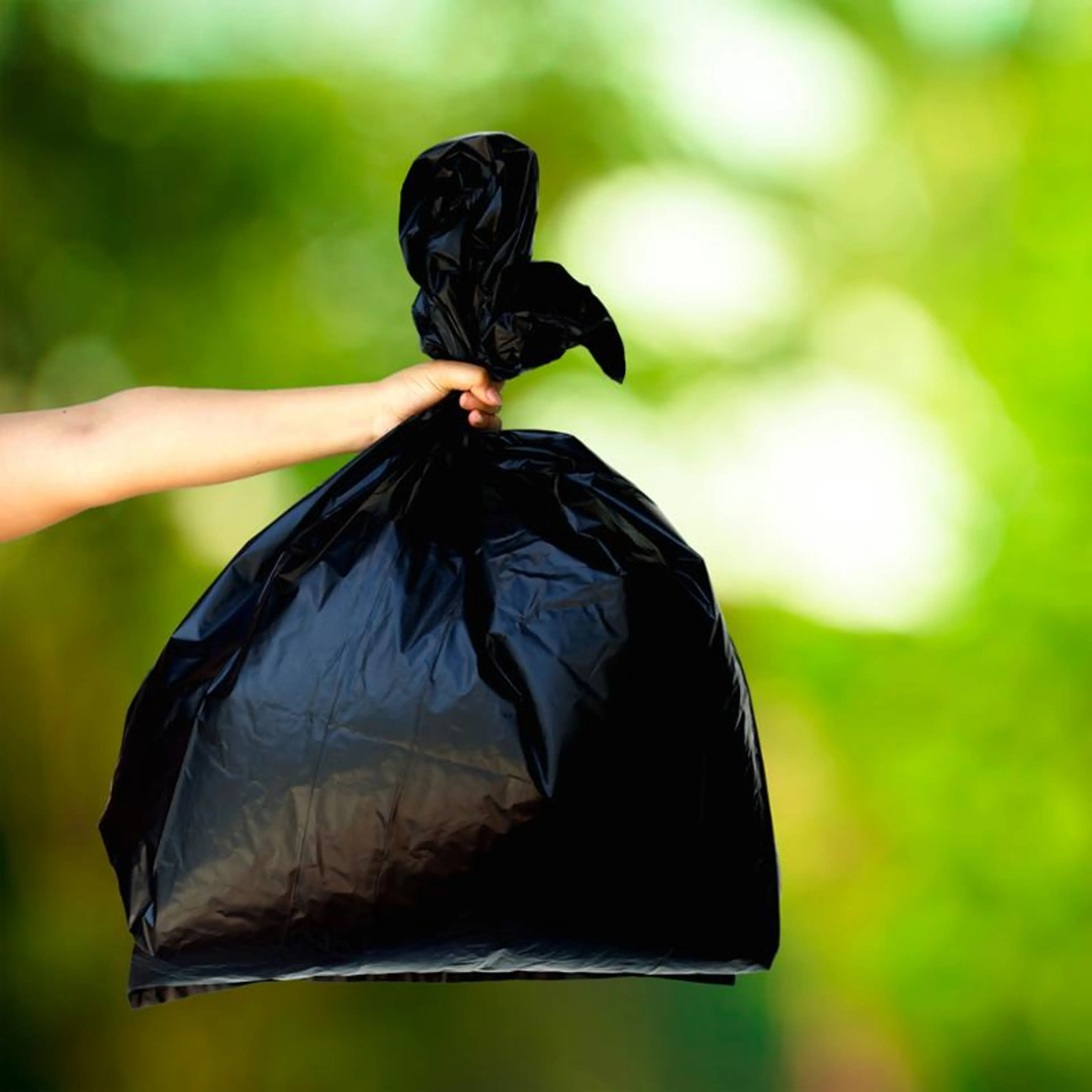 Co-ex avfallssekk på grønn bakgrunn