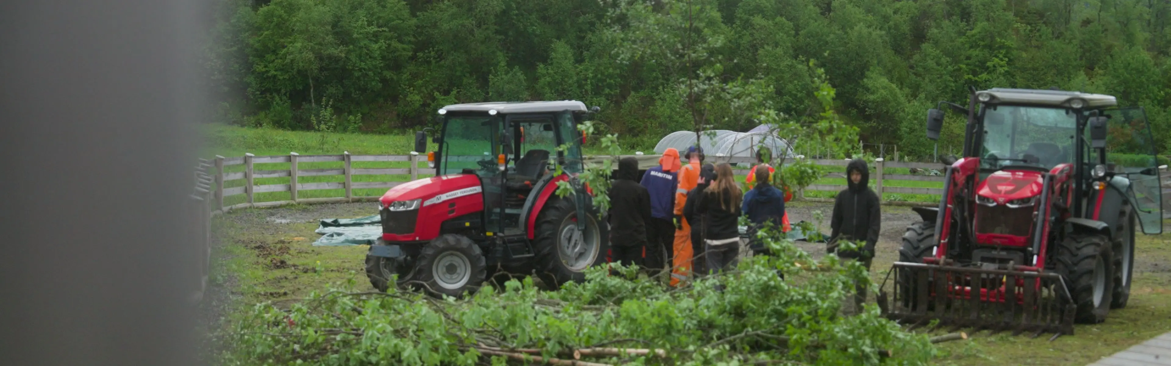 Personer står rundt traktor