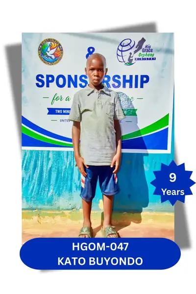Boy in an olive polo shirt and denim shorts standing before a banner