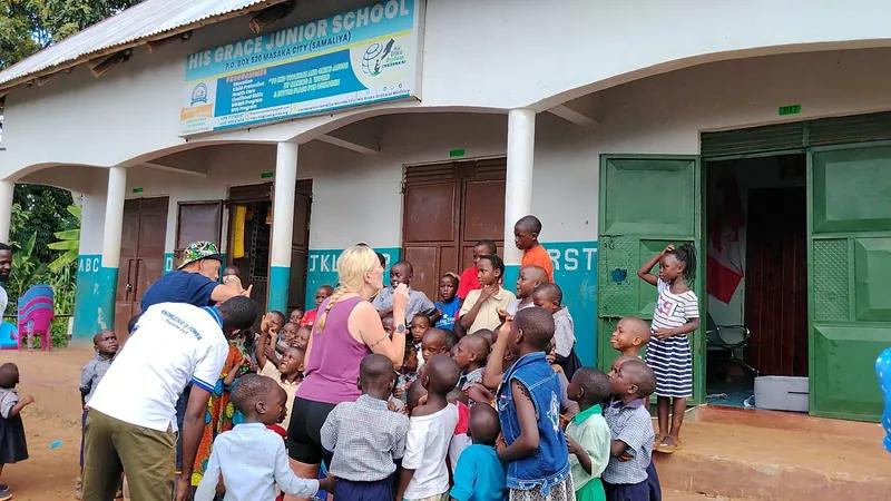 Children gathered outside the His Grace Junior School building