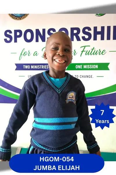 Boy in a striped navy sweater grinning with a gap-toothed smile