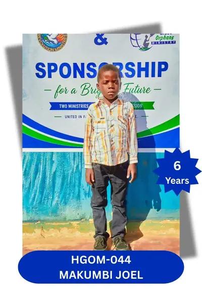 Boy in a plaid long-sleeve shirt and dark trousers standing before a sponsorship banner