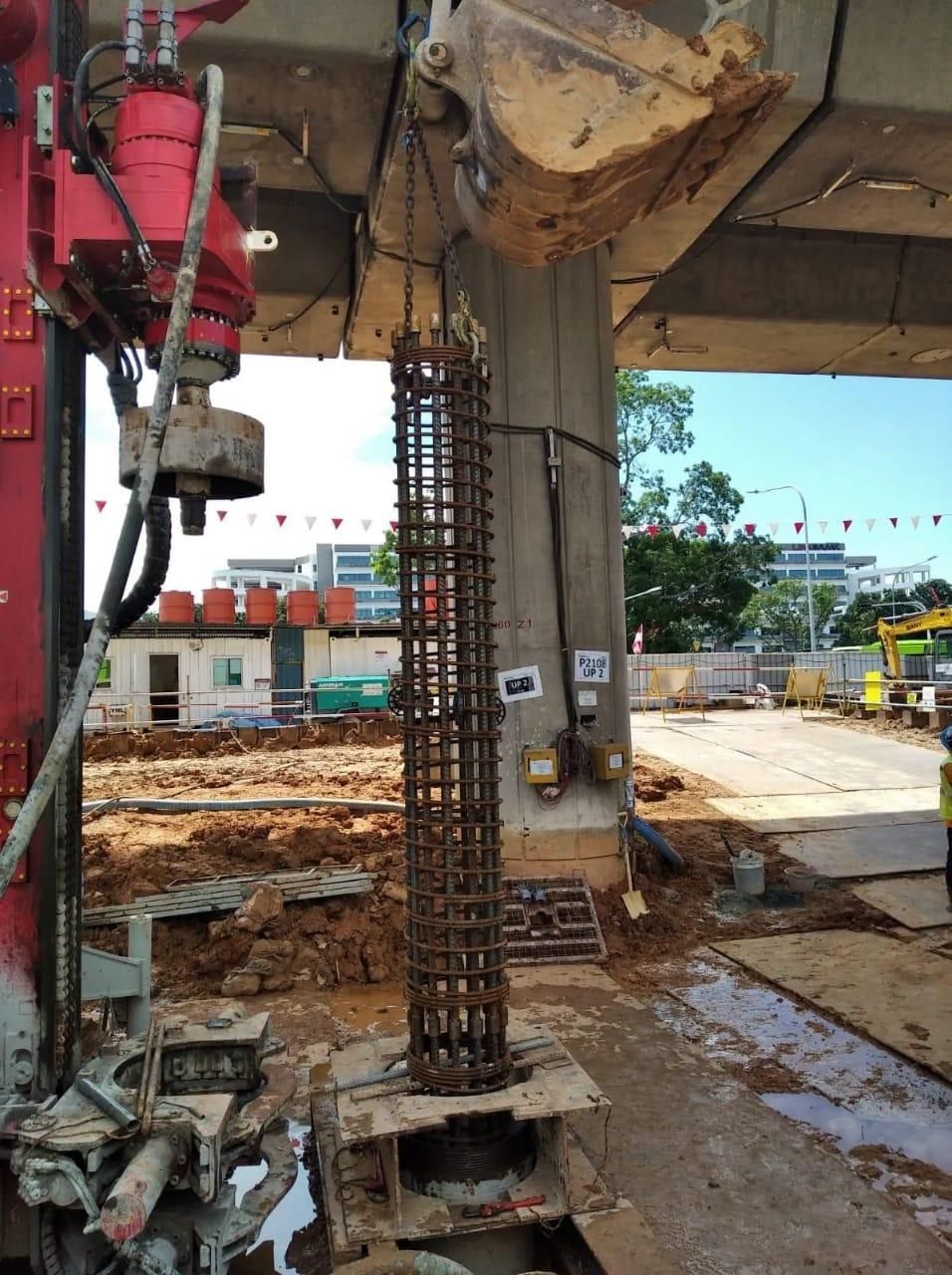 Steel reinforcement cage lifted into position for a bored cast in-situ pile