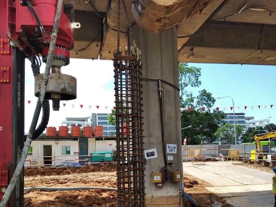 Steel reinforcement cage lifted into position for a bored cast in-situ pile