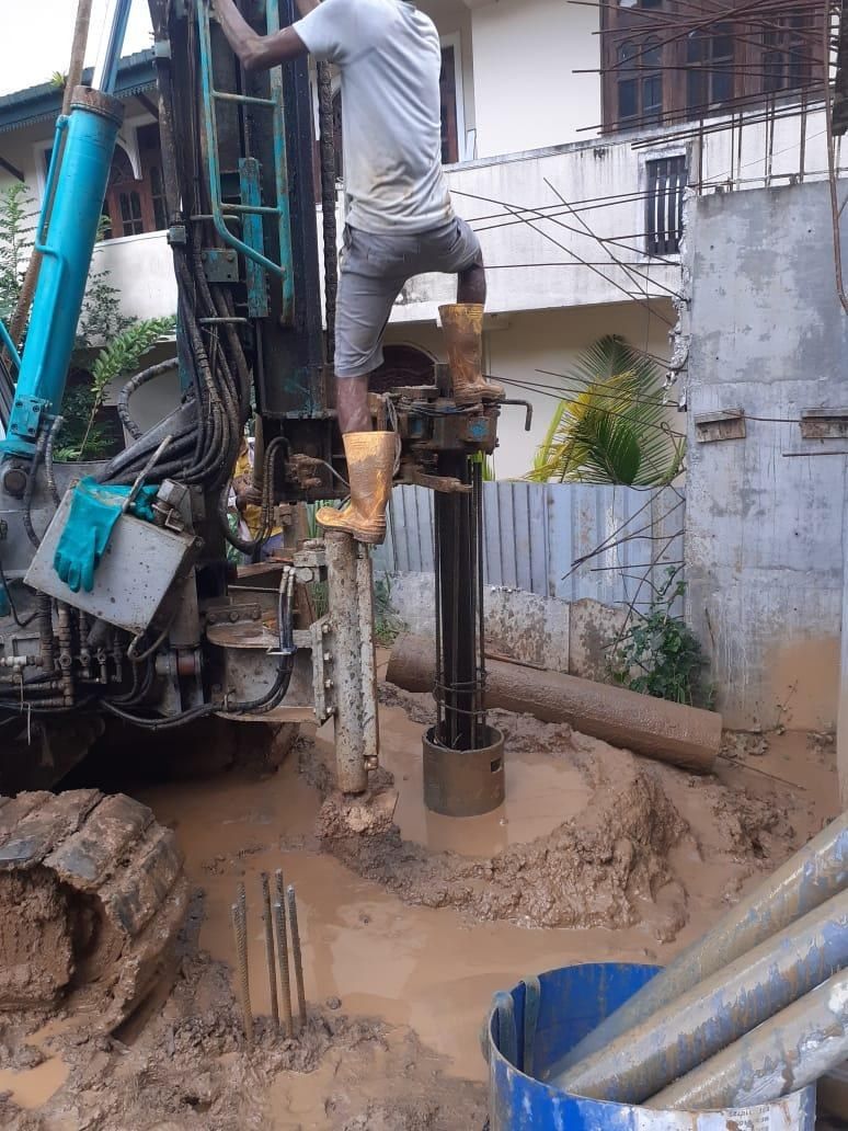 Micro pile rig drilling beside an existing house on a tight residential plot