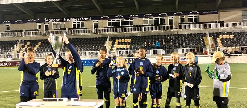 Photo of girls lifting cup