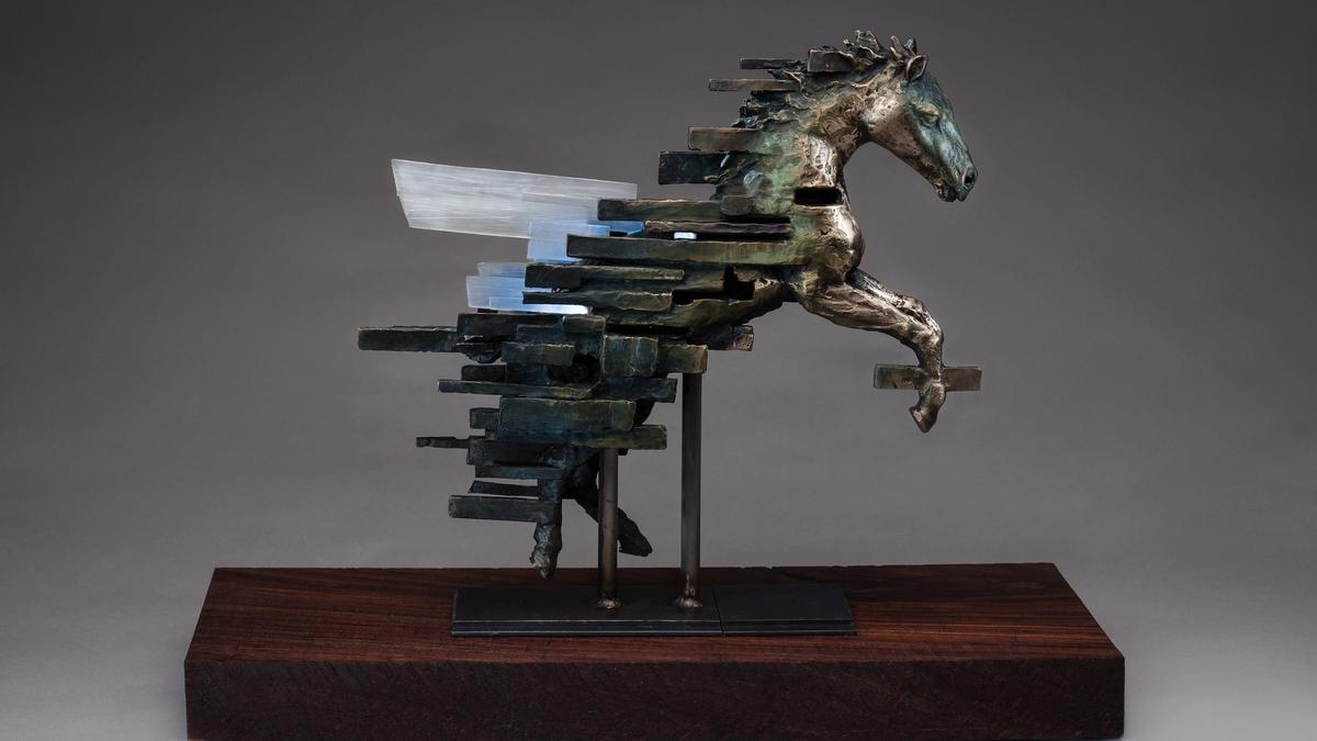 A bronze sculpture of a horse, illuminated from within