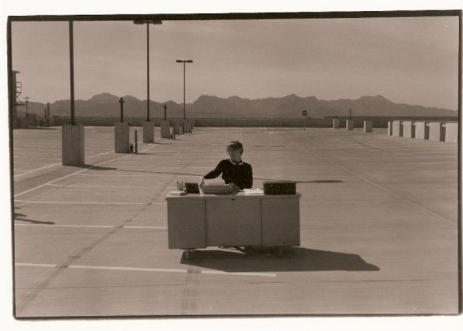 Woman working at a desk in a parking lot