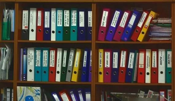 Binders and papers on shelf