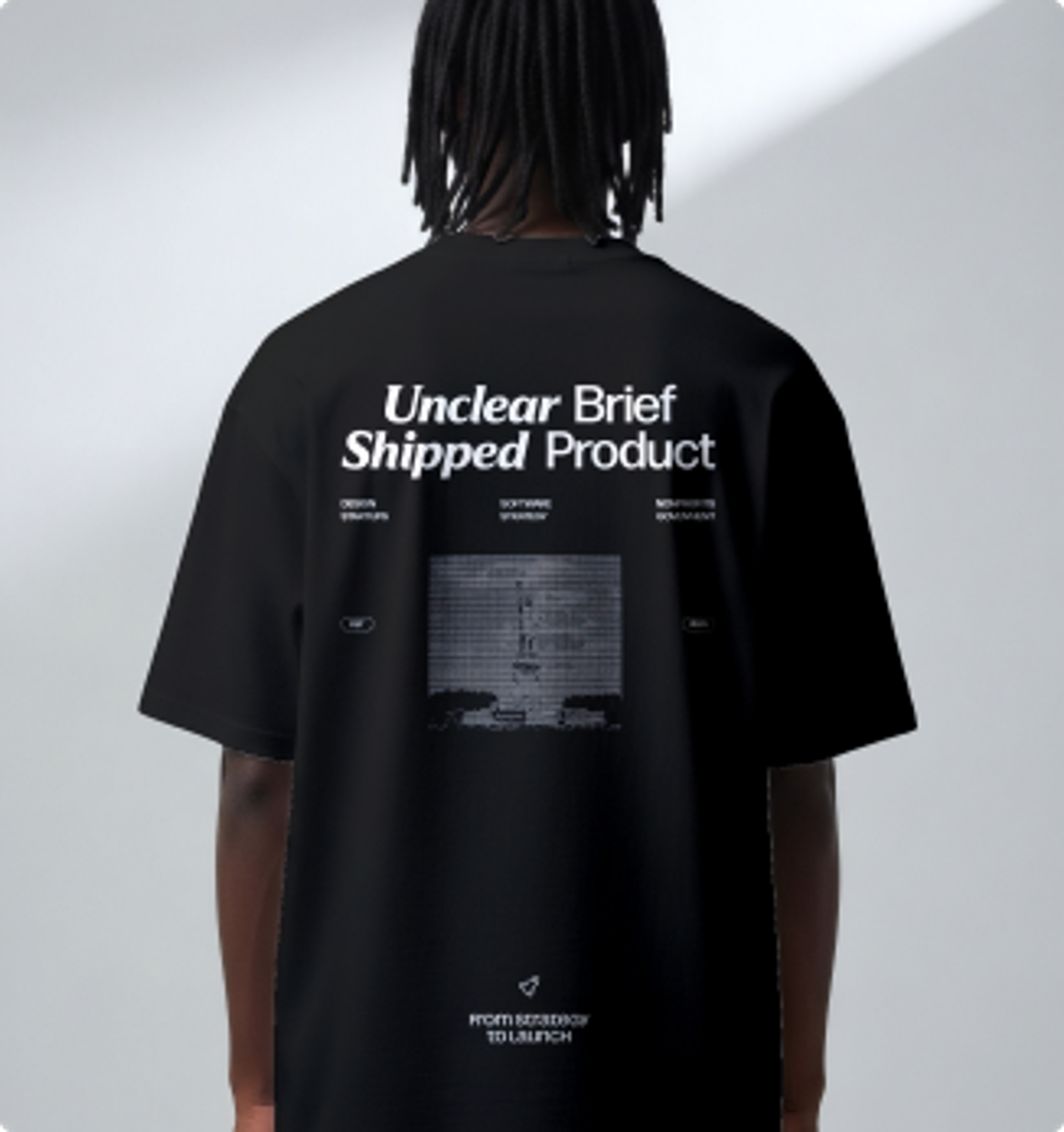 The back of a black Ghost Savvy t-shirt reading “Unclear brief, shipped product.”