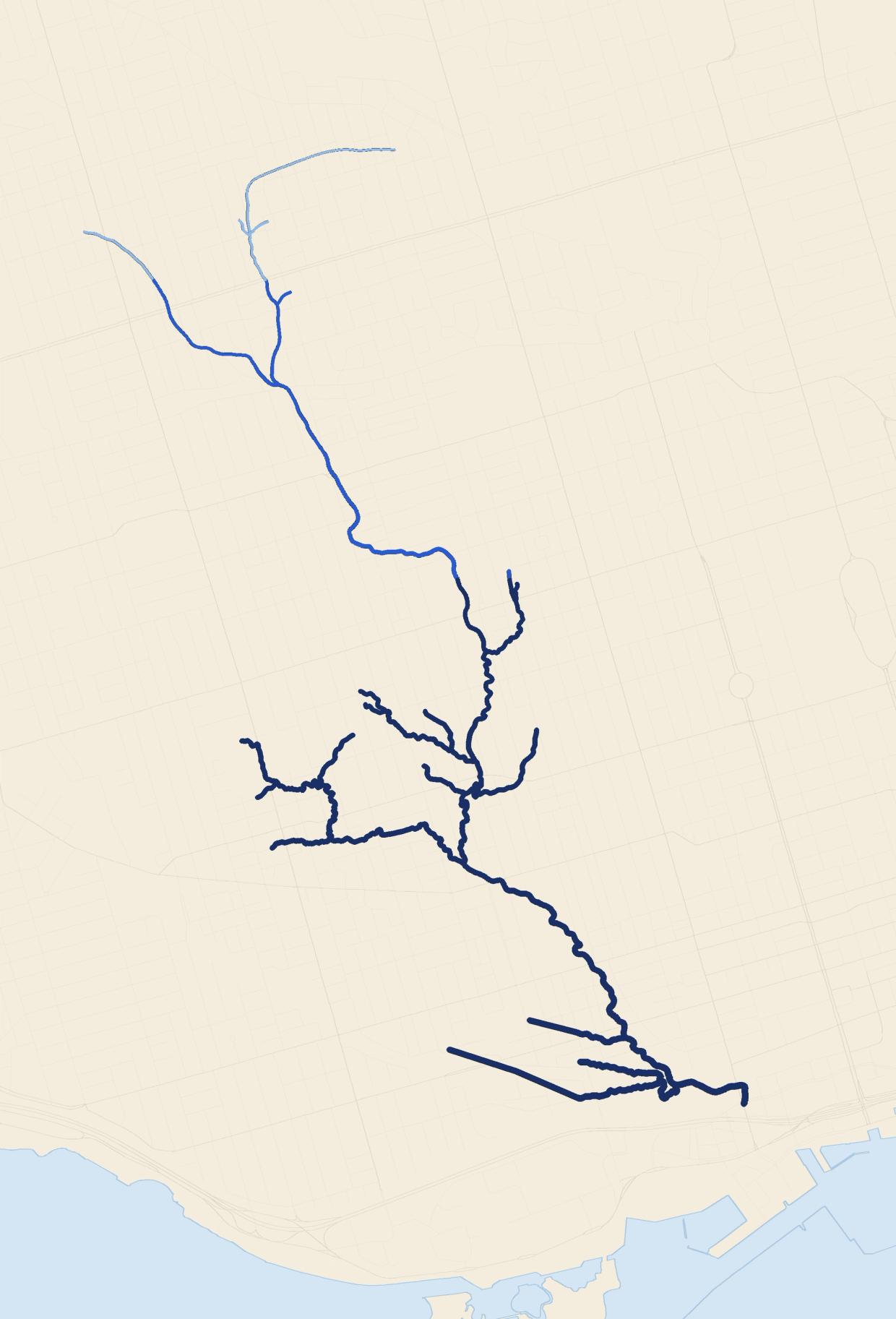 A map of Garrison Creek's buried course through Toronto, the line running from pale blue at the headwaters to deep navy at the mouth on Lake Ontario.