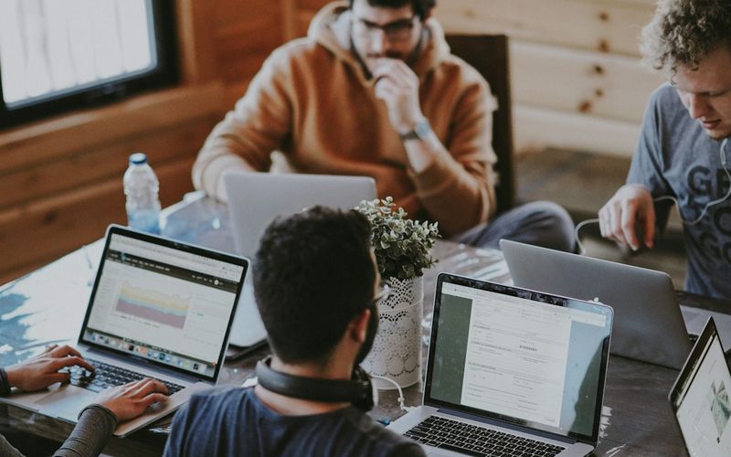 Business partners shaking hands over a conference table