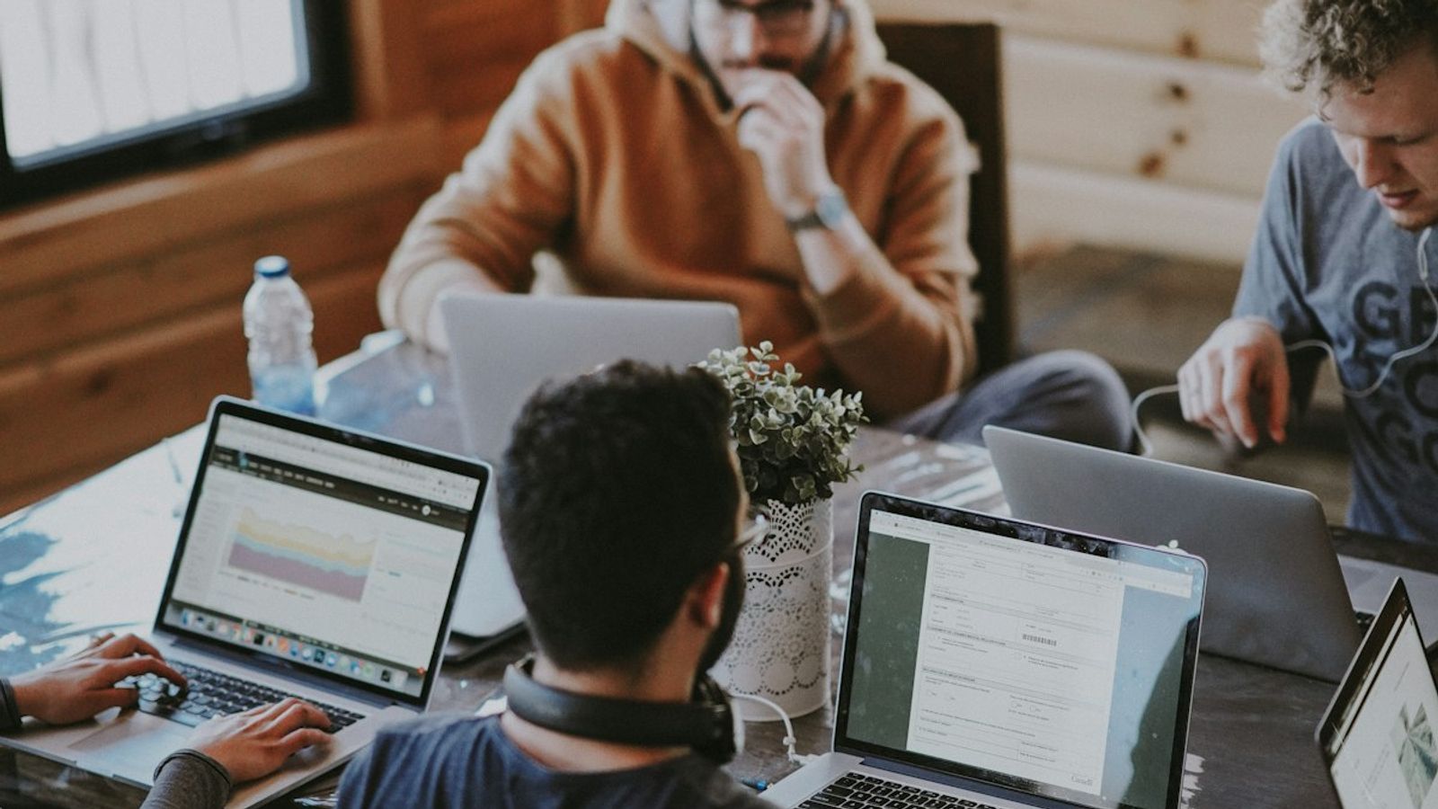 Business partners shaking hands over a conference table