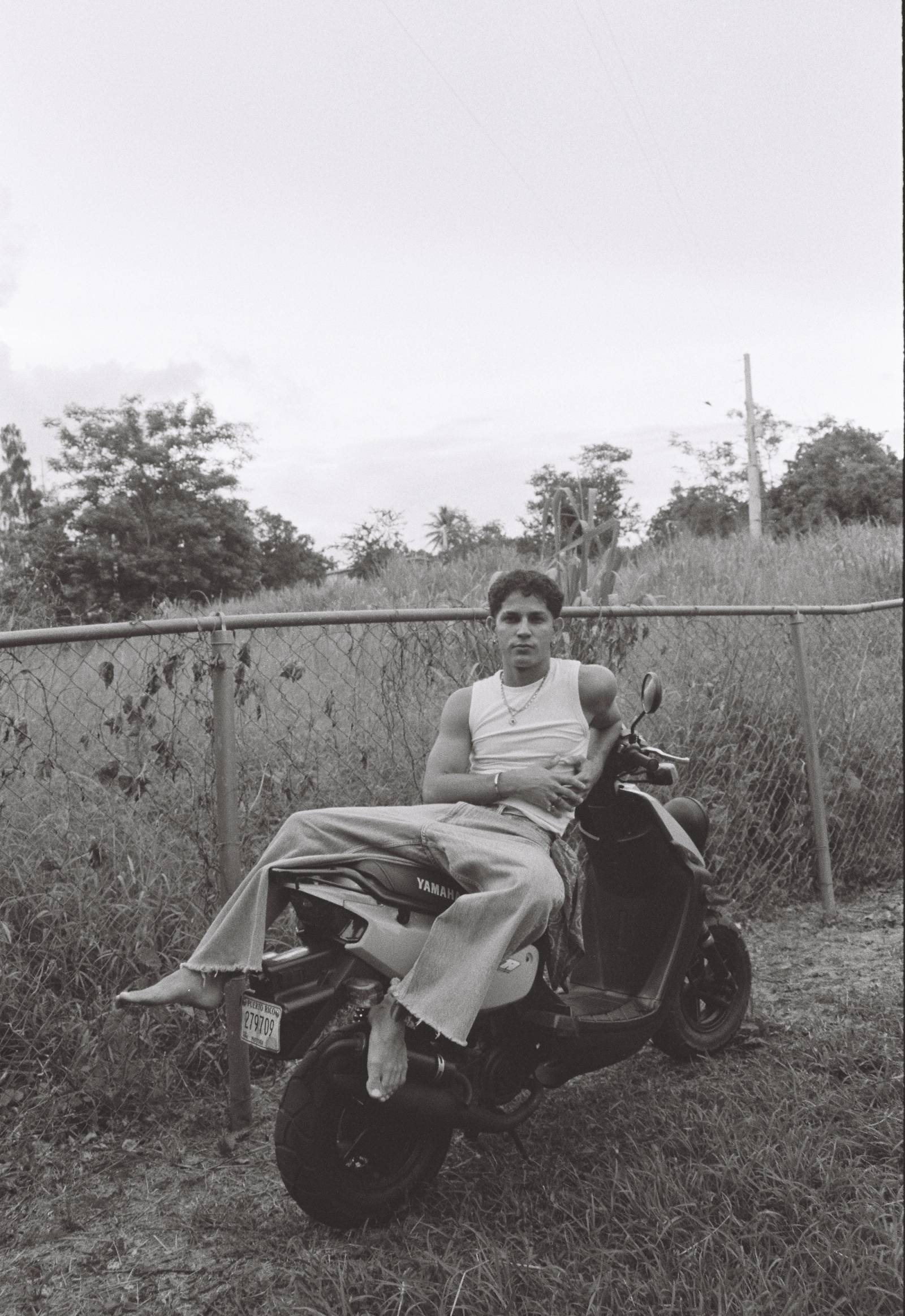 Didiel González Rodríguez seated on a scooter outdoors in Puerto Rico