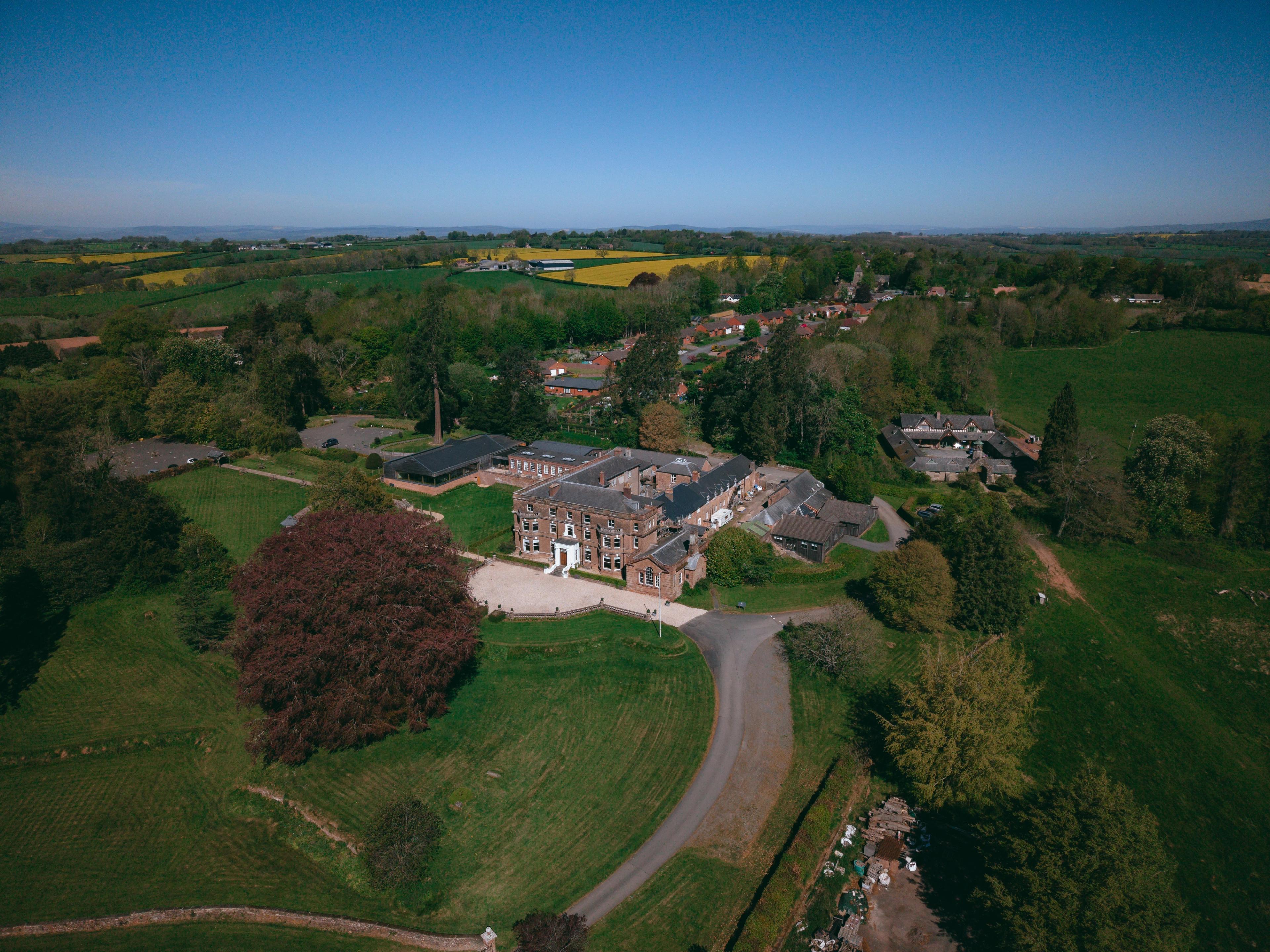 Aerial view of Bredenbury Court Barns and its parkland in the Herefordshire countryside, by Pixton Media