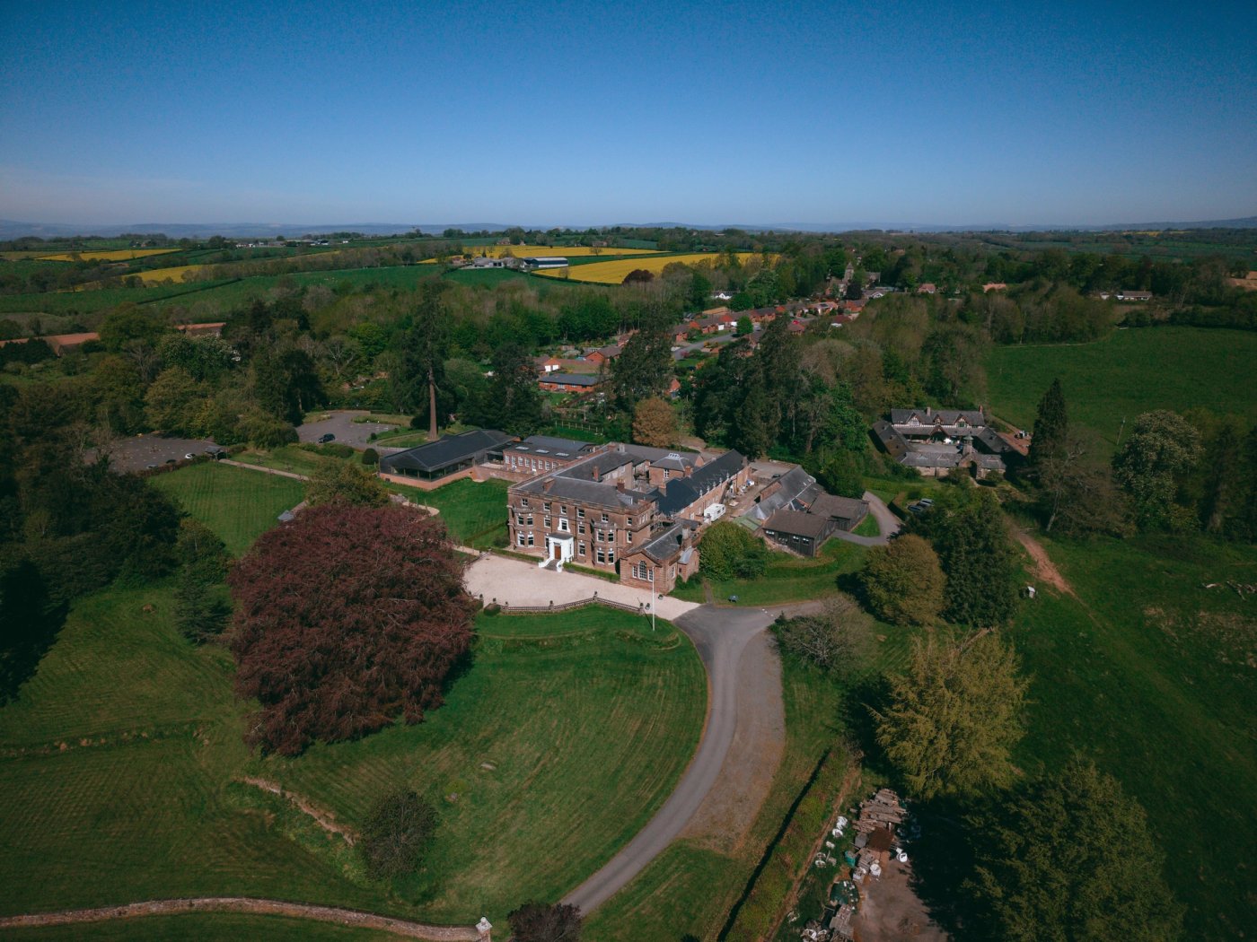 Aerial view of Bredenbury Court Barns and its parkland in the Herefordshire countryside, by Pixton Media