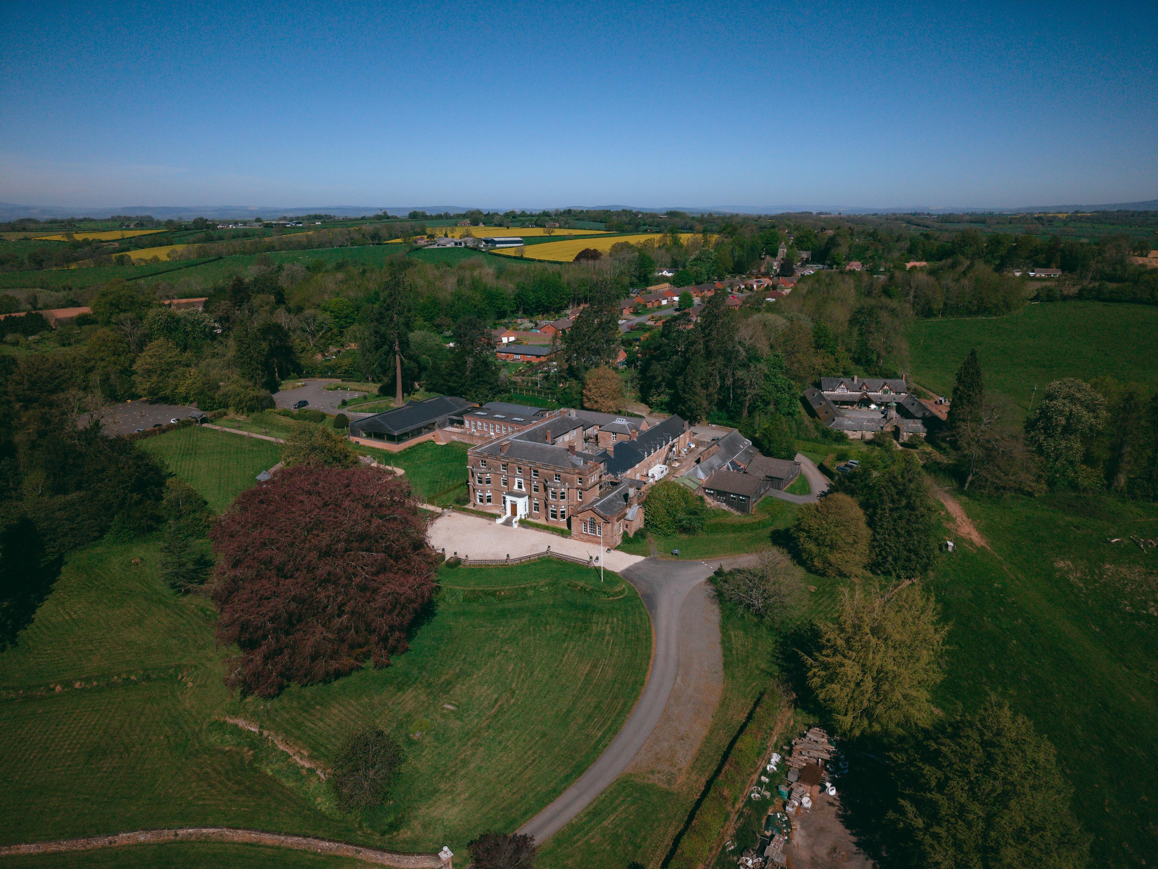 Aerial view of Bredenbury Court Barns and its parkland in the Herefordshire countryside, by Pixton Media