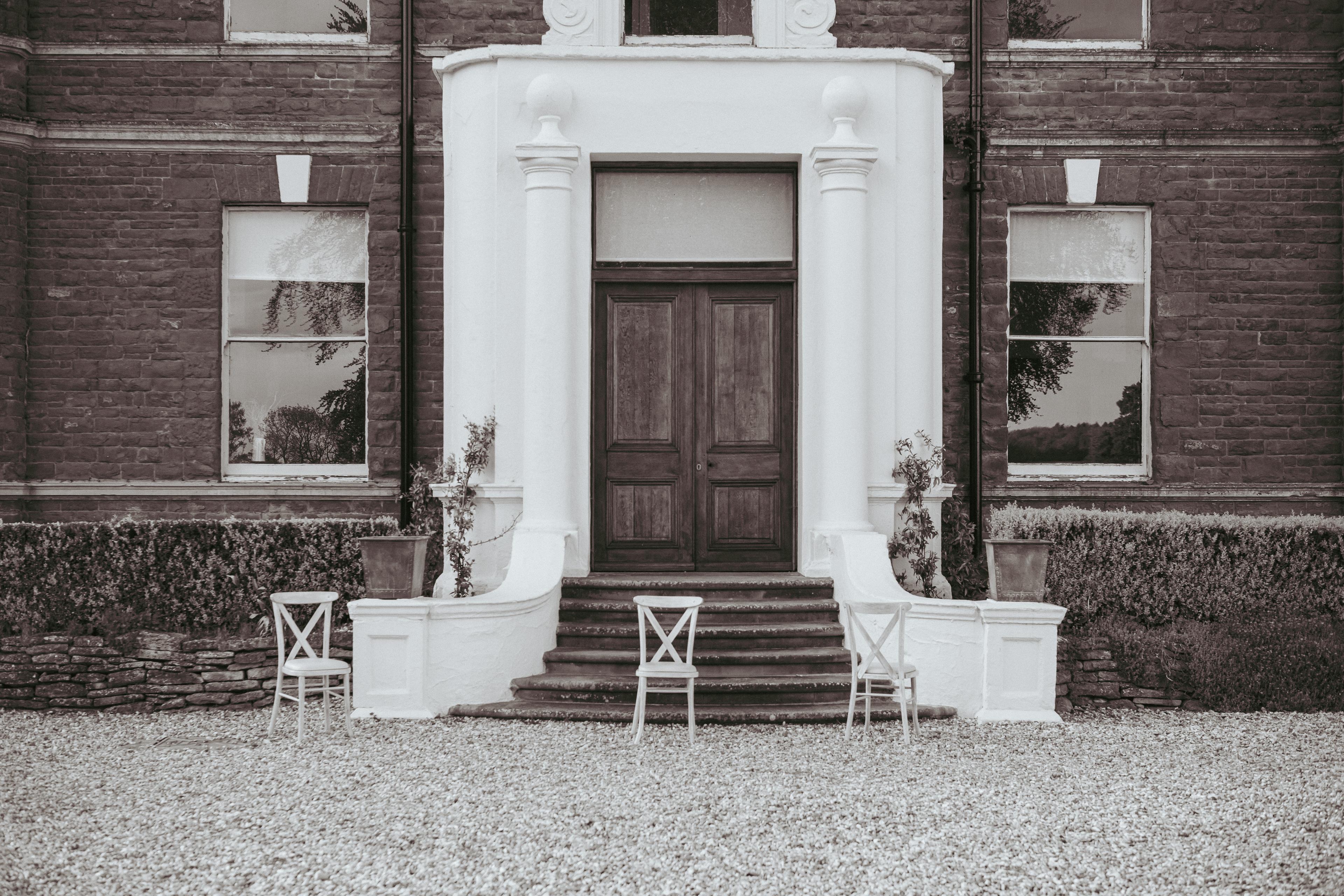 The white portico and wooden doors of the manor house at Bredenbury Court Barns, Herefordshire