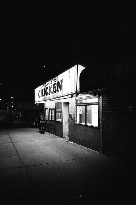 chicken shop on a corner at night