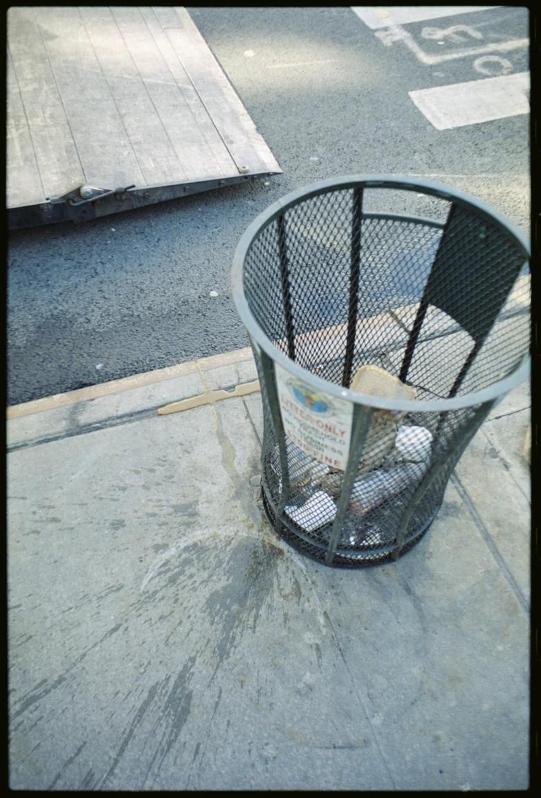 a trashcan in the middle of the city