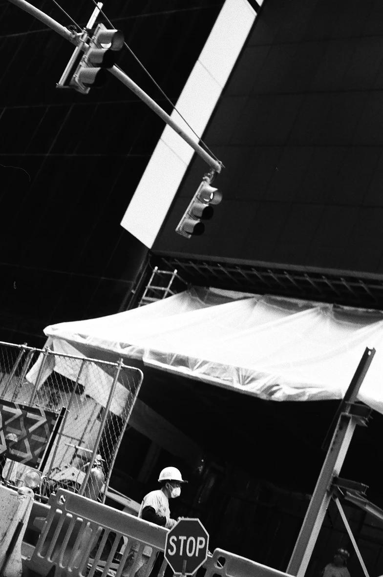 A construction working standing beneath a pavillion