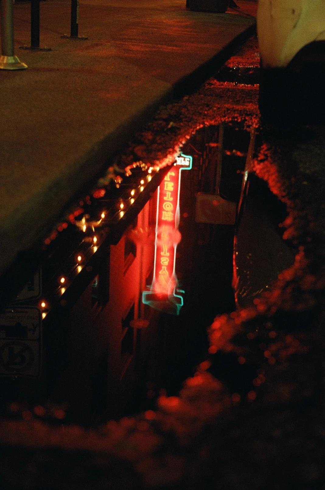 Puddle of water reflects the city lights in the night