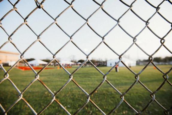 looking on the football field through the fence at the niké sb 51 event