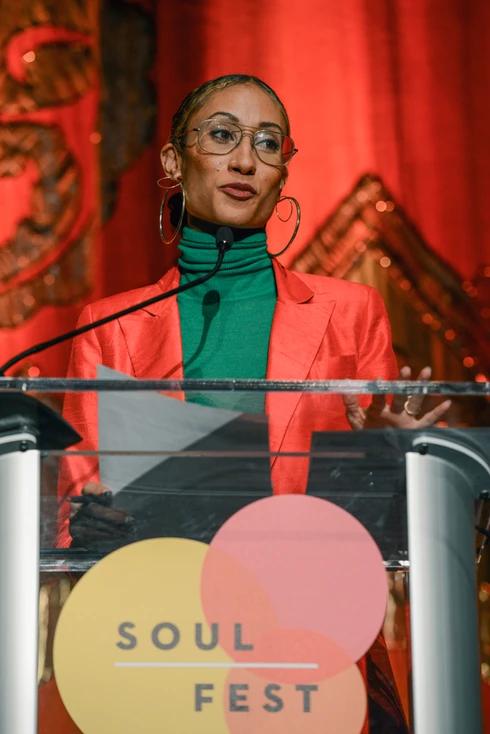 A woman at the microphone on stage at the Google Soulfest